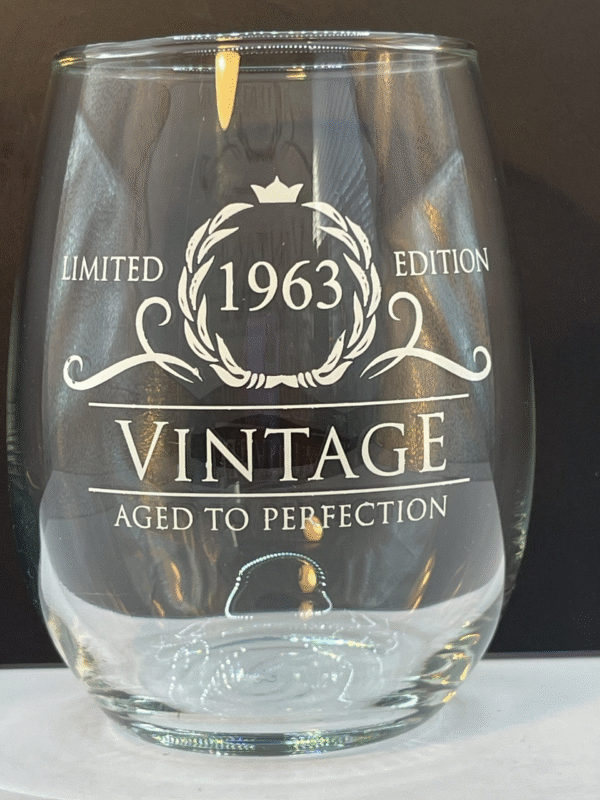 Front image of a clear stemless wine glass that says 1963 Vintage aged to perfection