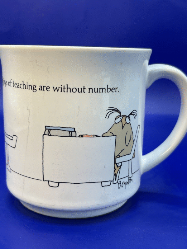 A charming vintage 8-ounce white ceramic mug designed by Sandra Boynton will surely bring a smile to your face.