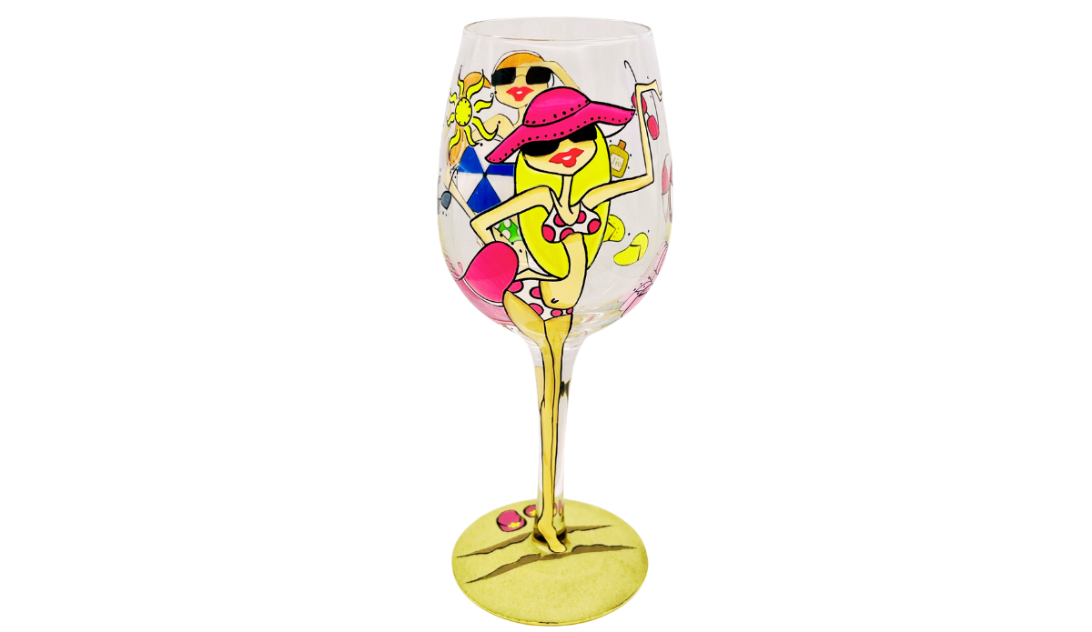 Beach Girls Hand Painted Wine Glass featuring lounging pink hat beach girl with sunshine, beach accessories, and partial beach ball scene