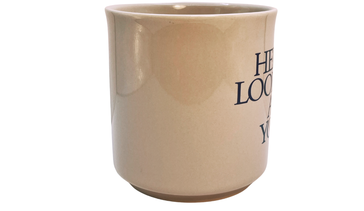 3D Eyeball Mug middle view showing the smooth cream ceramic side with part of the front message visible.