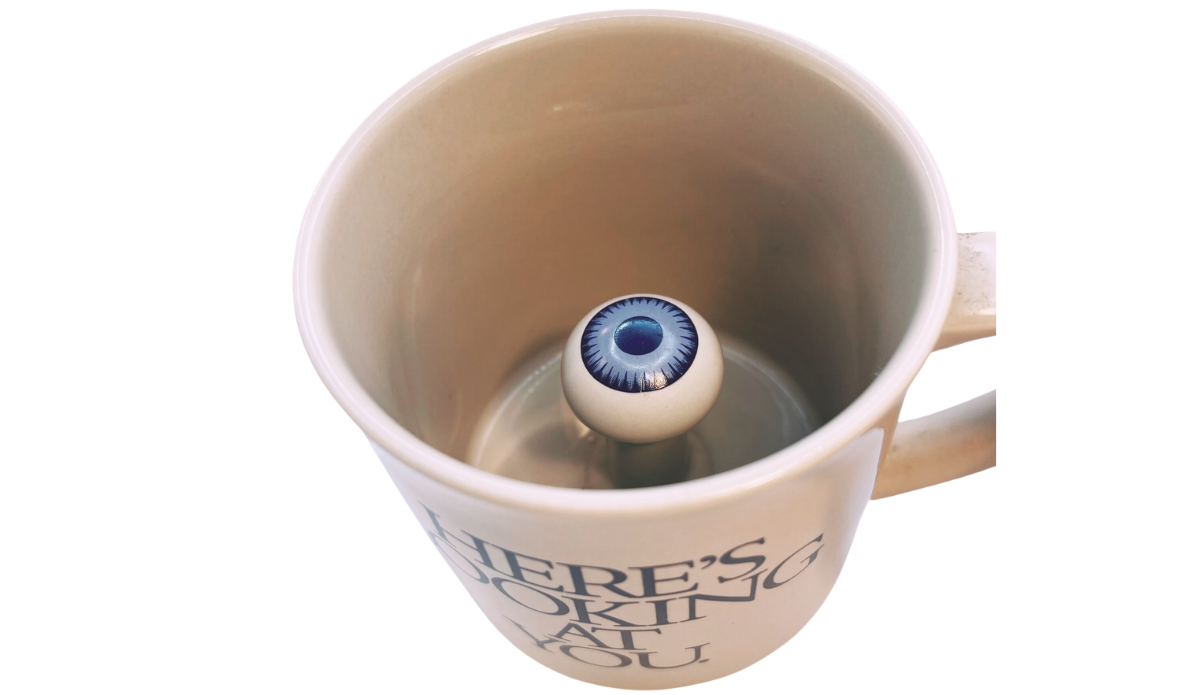 3D Eyeball Mug inside view revealing the raised blue eyeball hidden at the bottom of the cream ceramic mug.