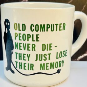 White ceramic Old Computer People Funny Mug with green lettering and black silhouette