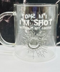 Close-up of bullet hole design in clear glass mug