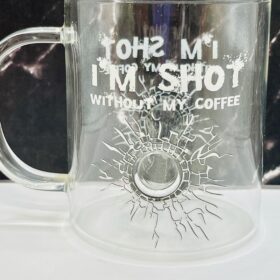 Close-up of bullet hole design in clear glass mug