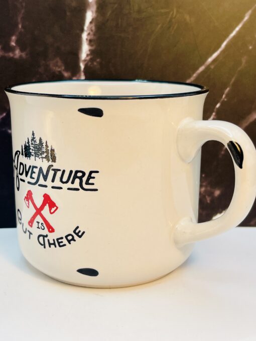 White enamel mug with crossed axes and tree design