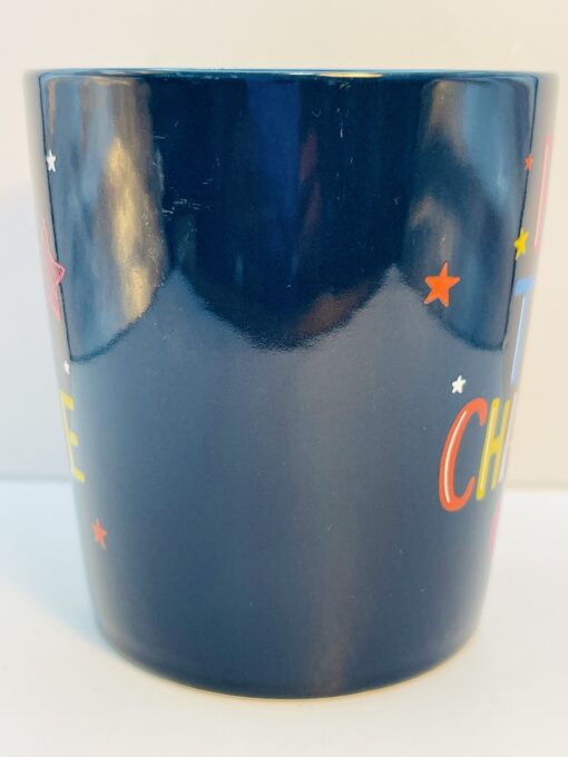 Vibrant ceramic mug featuring BE THE CHANGE design