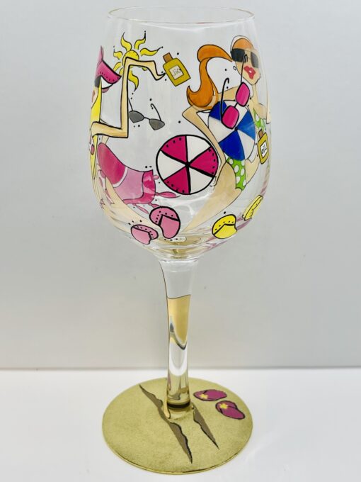 Hand-painted beach scene wine glass with two women by the shore