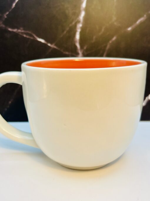 Rae Dunn mug with peach interior