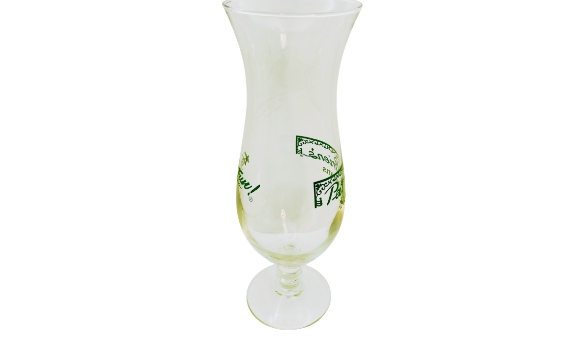 Side view of Vintage Pat O’Brien’s New Orleans Hurricane Glass showing tall flared shape and wraparound green graphics