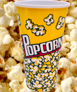 Solo yellow popcorn bucket displayed against a background filled with freshly popped popcorn