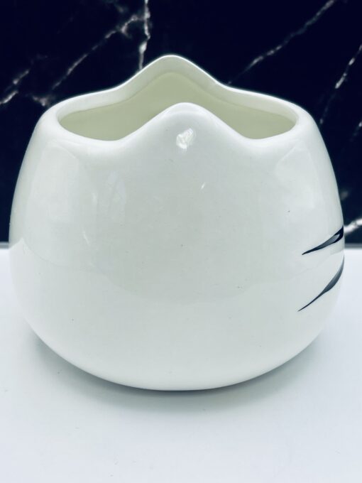 Stylized white cat mug with ears and whiskers