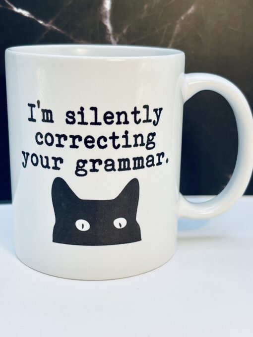 Silently Correcting Your Grammar Cat Mug front view