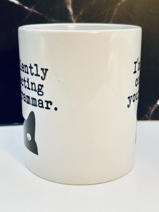 Funny grammar cat coffee mug with black text