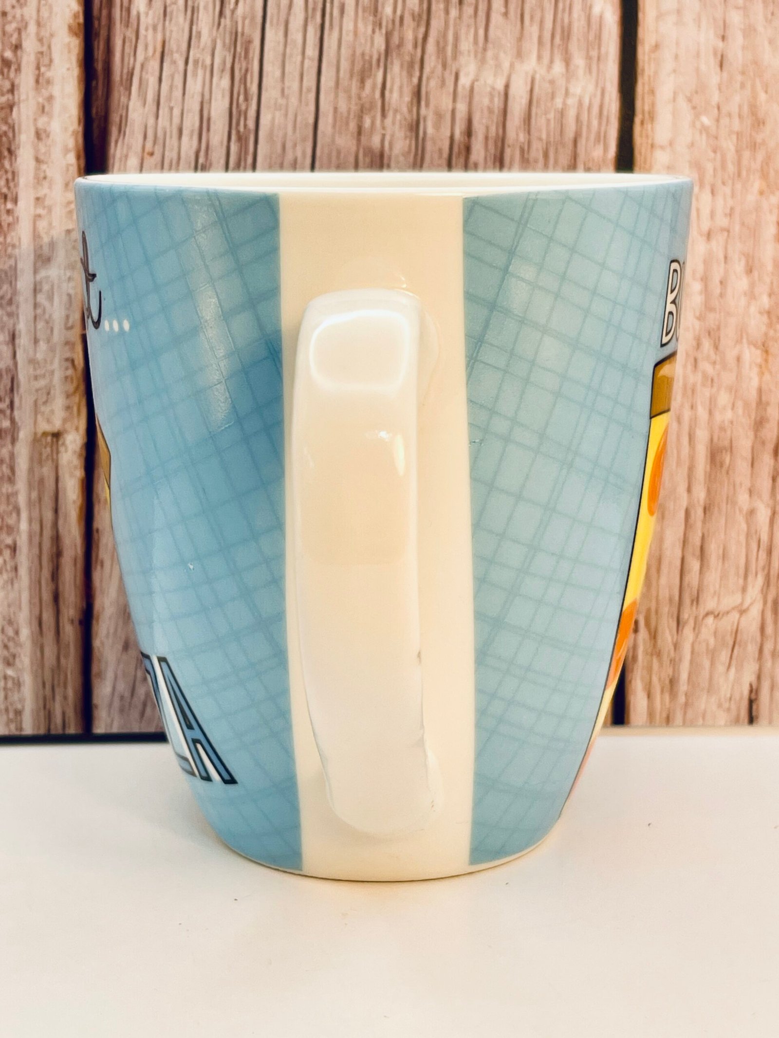 White ceramic pizza slice mug with text