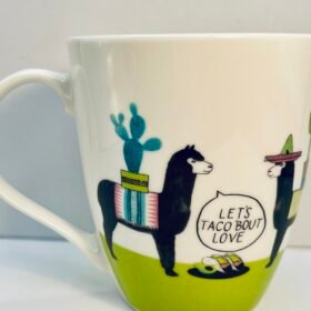 Close-up of ceramic llama mug with taco plate design