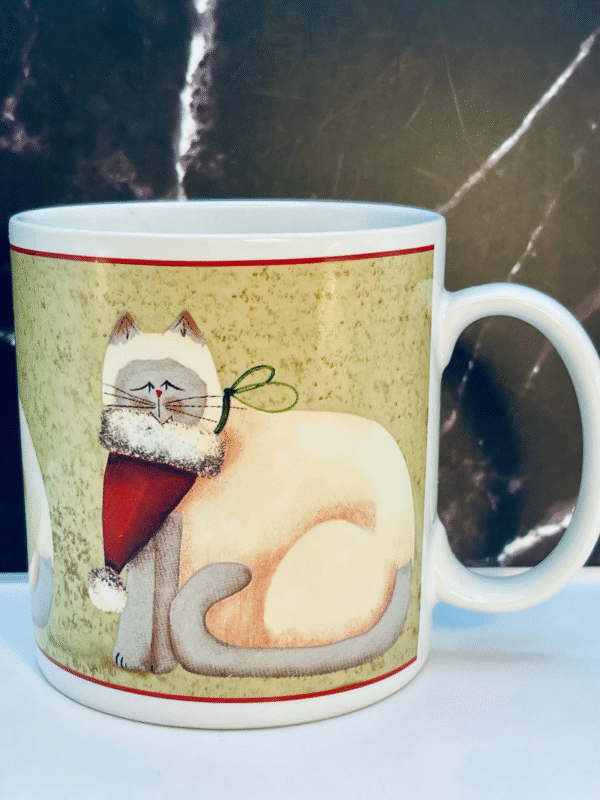 The Sakura Christmas Cats Stoneware Mug is a festive favorite for cat lovers and holiday collectors. Featuring a charming white cat in a red scarf and upside-down Santa hat, this stoneware mug brings playful holiday spirit to every sip.