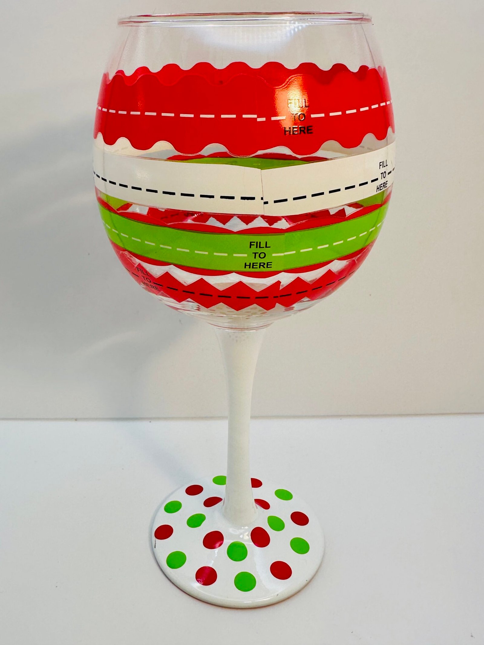 Red and green polka dot wine glass