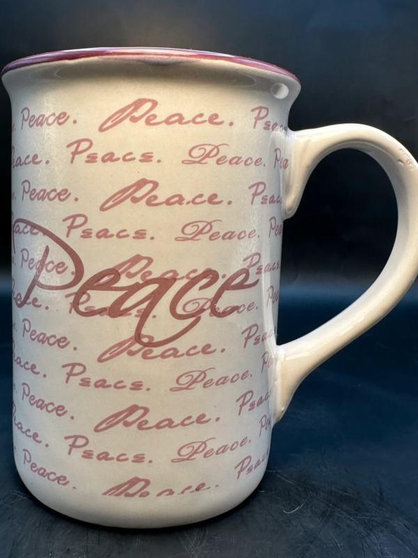 This Inspirational Peace Mug by Gibson is a 12 ounce white ceramic mug has a purple inside and the words Peace written all over.