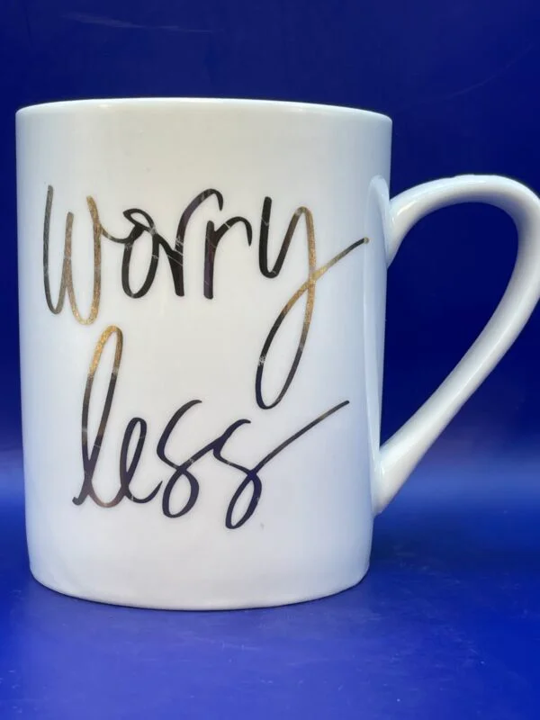 This elegant 12 ounce white porcelain Worry Less Mug by Prima Design has the words, "Worry Less" in gold writing on both sides. 