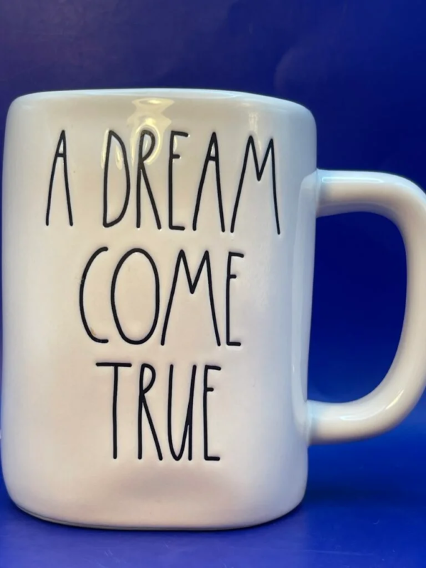 This elegantly designed 16 ounce white ceramic Rae Dunn mug says, A Dream Come True in black embossed letters.  
