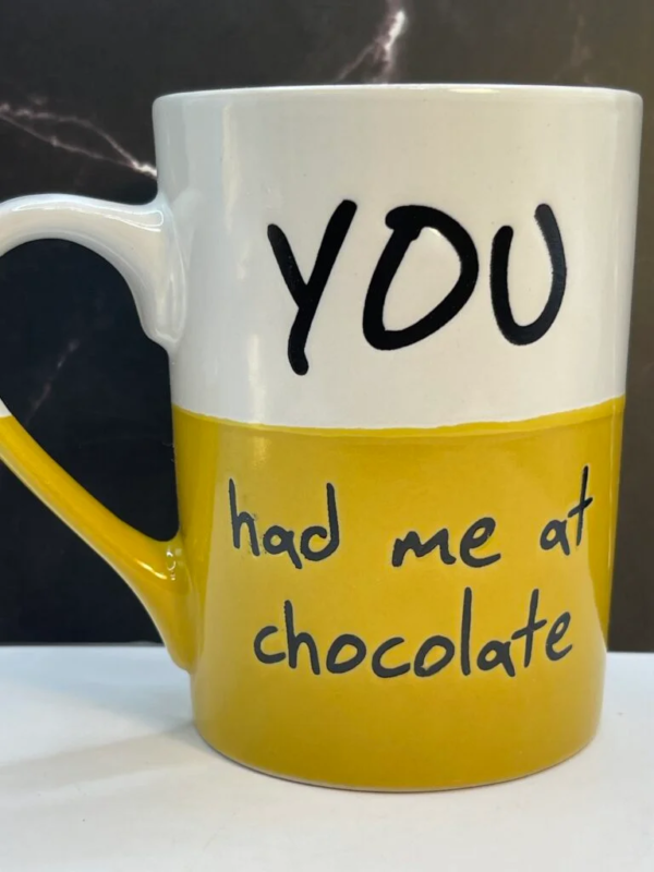 This 16-ounce two-toned ceramic Had Me Chocolate Jumbo Mug features a bright yellow bottom and a crisp white top. 