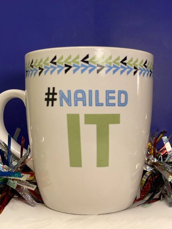 Oversized white ceramic mug with Nailed It on both sides. 