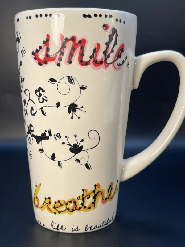 This is a 16 ounce elegantly designed Natural Stop Smile Breath Latte Mug.