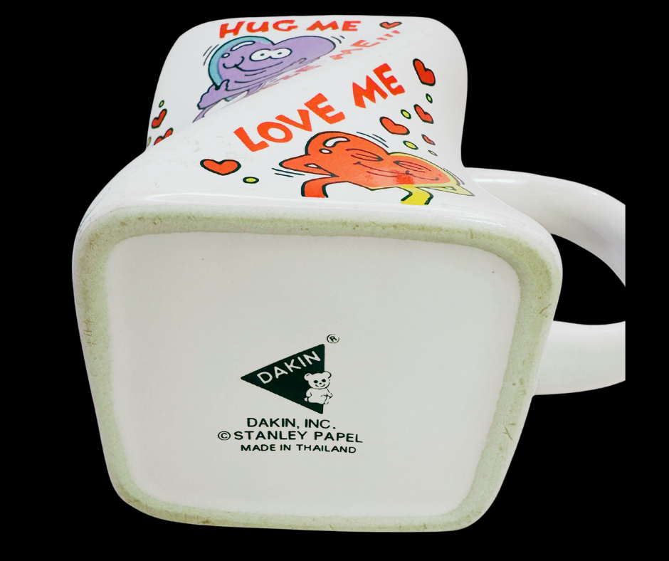 Vintage Dakin Hug Me Love Me Mug bottom view showing maker stamp