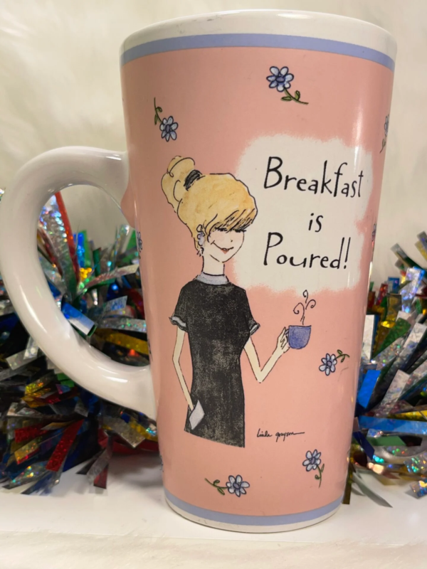 This pink ceramic extra large coffee cup has an image of a woman holding a cup of coffee with the words, “Breakfast is Poured!” prominently featured on both sides of this perfect gift mug.