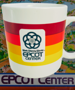 vintage epcot center mug displayed with disney park memorabilia