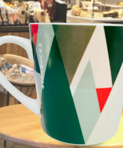 Starbucks pine tree forest triangles mug styled in Starbucks cafe setting