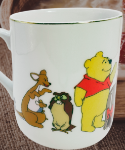 Disney Winnie the Pooh mug styled in cozy breakfast setting with warm nostalgic atmosphere