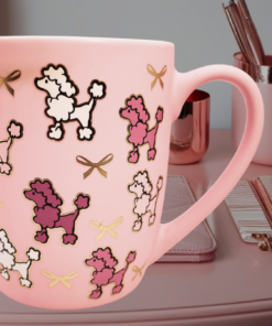 pink poodle mug styled on pink desk with feminine decor and gold accents