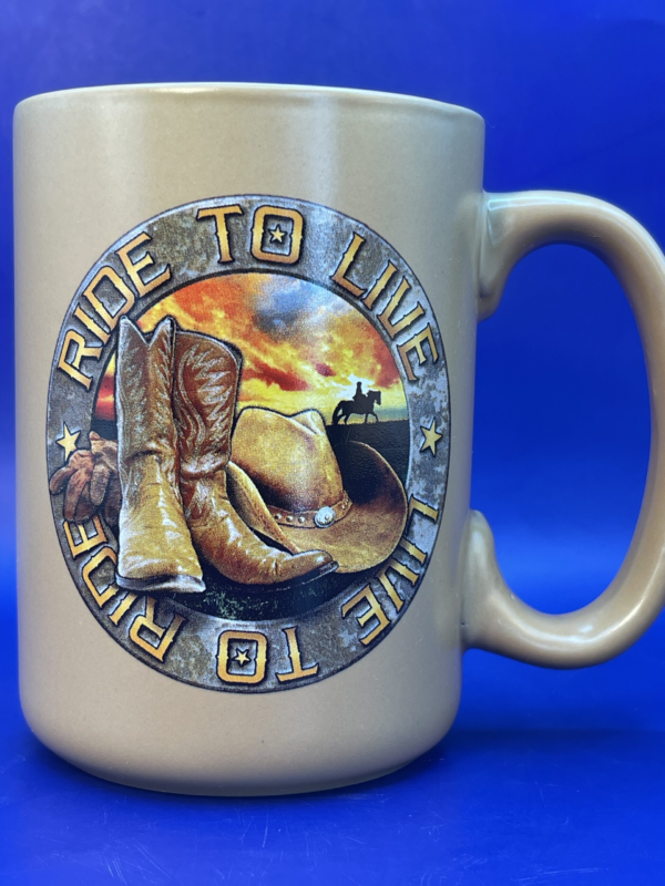  the centerpiece of this mug is a captivating circle featuring cowboy boots and a hat . It’s set against a backdrop of a silhouette riding into the sunset.