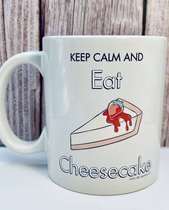 On one side, the Golden Girls Keep Calm Cheesecake Mug proudly displays the fabulous foursome in all their glory. Dorothy’s dry wit, Blanche’s Southern sass, Rose’s sweet naivety, and Sophia’s iconic snark.

Conversely, flip it around, and you’ll find the secret to surviving any crisis (or coworker): Keep Calm and Eat Cheesecake. Beneath the words sits a mouthwatering image of creamy cheesecake topped with glossy strawberry glaze—a dessert as legendary as the ladies themselves.