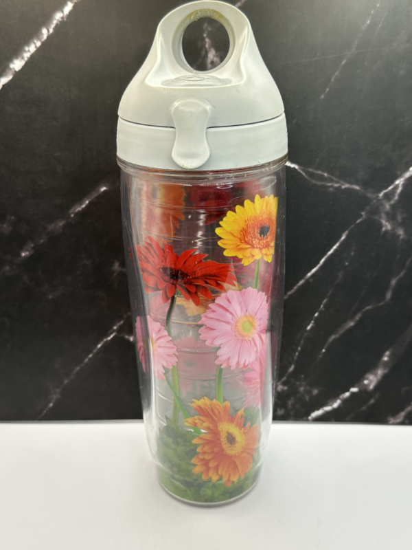 This 24-ounce double-wall insulated Zinnia Tervis Tumbler is is the perfect blend of practicality and charm.

It features vibrant, colorful zinnias blooming all over a clear background.