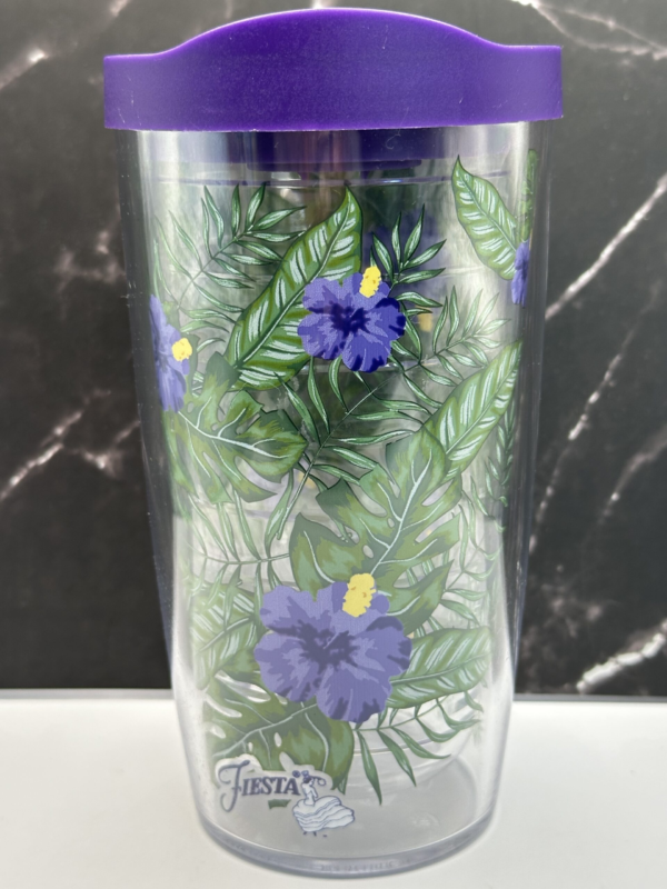 This 16-ounce double-walled insulated Purple Hibiscus Tervis Tumbler features an eye-catching design of vibrant purple hibiscus flowers. They’re surrounded by lush green foliage. Especially creating a lively, nature-inspired look.