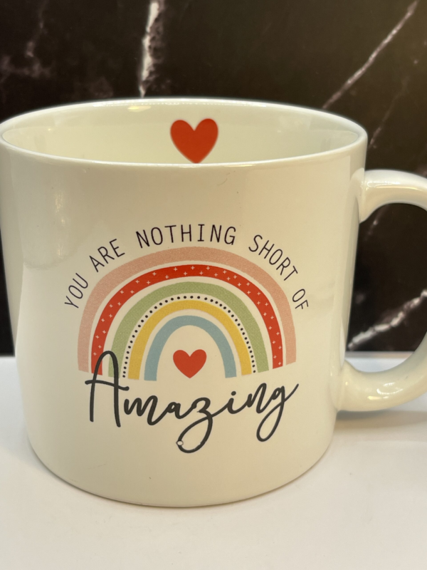 Start your day with a burst of color and a big dose of positivity with this 24-ounce white ceramic mug Nothing Short Amazing Jumbo Mug. 