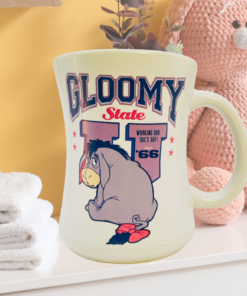Disney Eeyore Gloomy State mug styled in cozy room with soft decor and plush bunny background