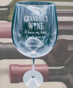 grandma wine glass with engraved Grandma’s Wine message displayed with wine bottles in home setting