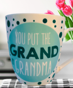 You Put The Grand In Grandma mug with pink tulips on table
