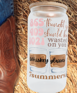 western cowgirl frosted glass tumbler styled with cowboy boots rustic setting