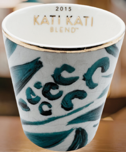 starbucks kati kati tasting cup in starbucks coffee shop setting teal pattern gold rim