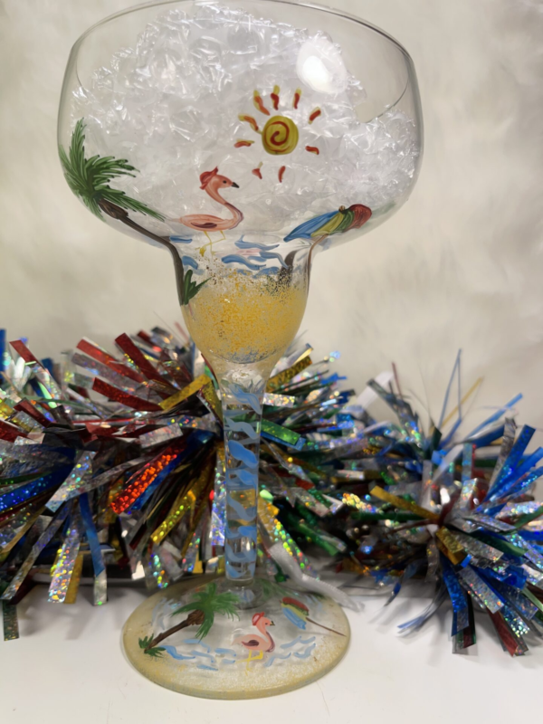 If you can’t get to the beach, let the beach come to you in this hand painted beach themed margarita glass. The whimsical design includes everything you need to indulge your favorite beach fantasies.