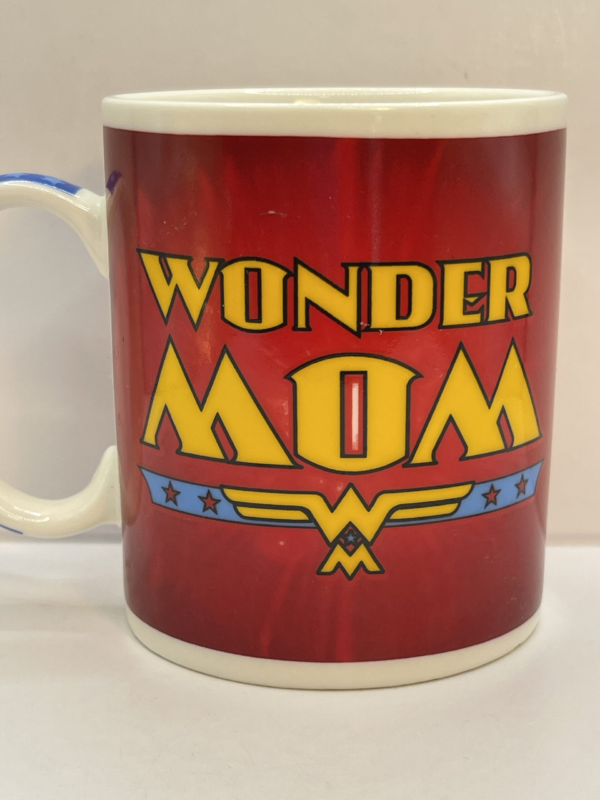 This vibrant 8-ounce white ceramic mug takes inspiration from the iconic Wonder Woman colors. The deep red body is perfectly framed by a striking blue handle adorned with white stars. Because a Wonder Mom deserves nothing less than star-studded recognition.