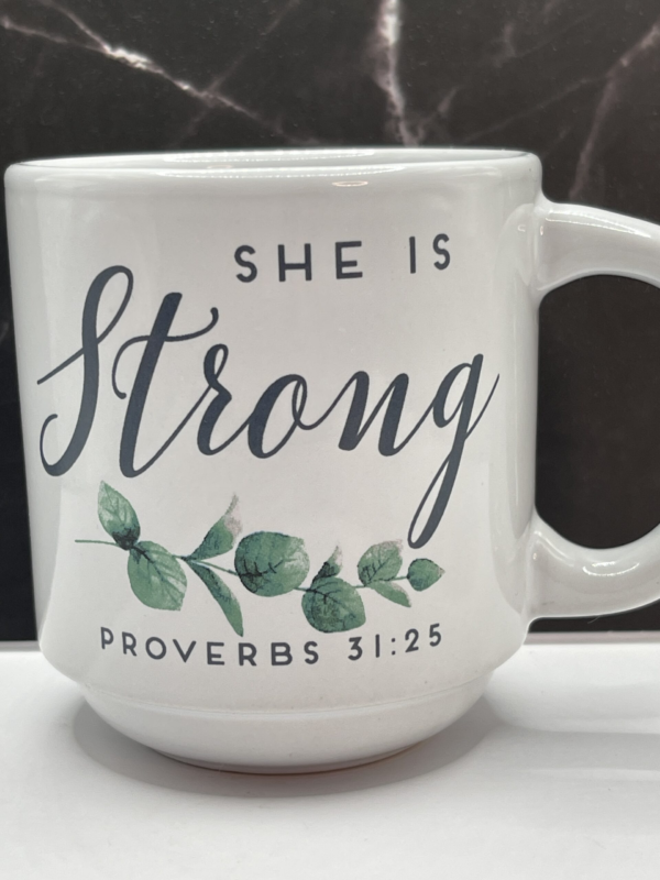 Celebrate the strength and grace of the women in your life with the She’s Strong Proverbs 31:25 Mug. It’s the perfect #cupofmood and a daily reminder of faith, resilience, and inner power.Indeed, this elegant 12-ounce white ceramic mug features the uplifting phrase “She Is Strong” . They’re in bold black letters on both sides.In fact, it serves as the perfect dose of encouragement to start any day.