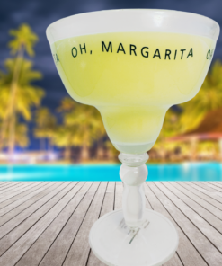 yellow margarita glass styled outdoors by pool with tropical background