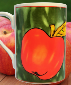Paul Cardew Apple Mug displayed with fresh apples in an orchard-inspired kitchen setting