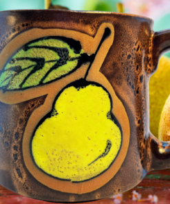 Vintage MCM pear pottery mug displayed with fresh pears in a rustic kitchen-inspired setting