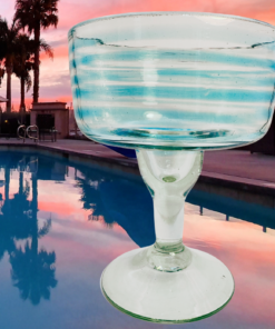 aqua swirl margarita glass poolside sunset setting coastal vibe